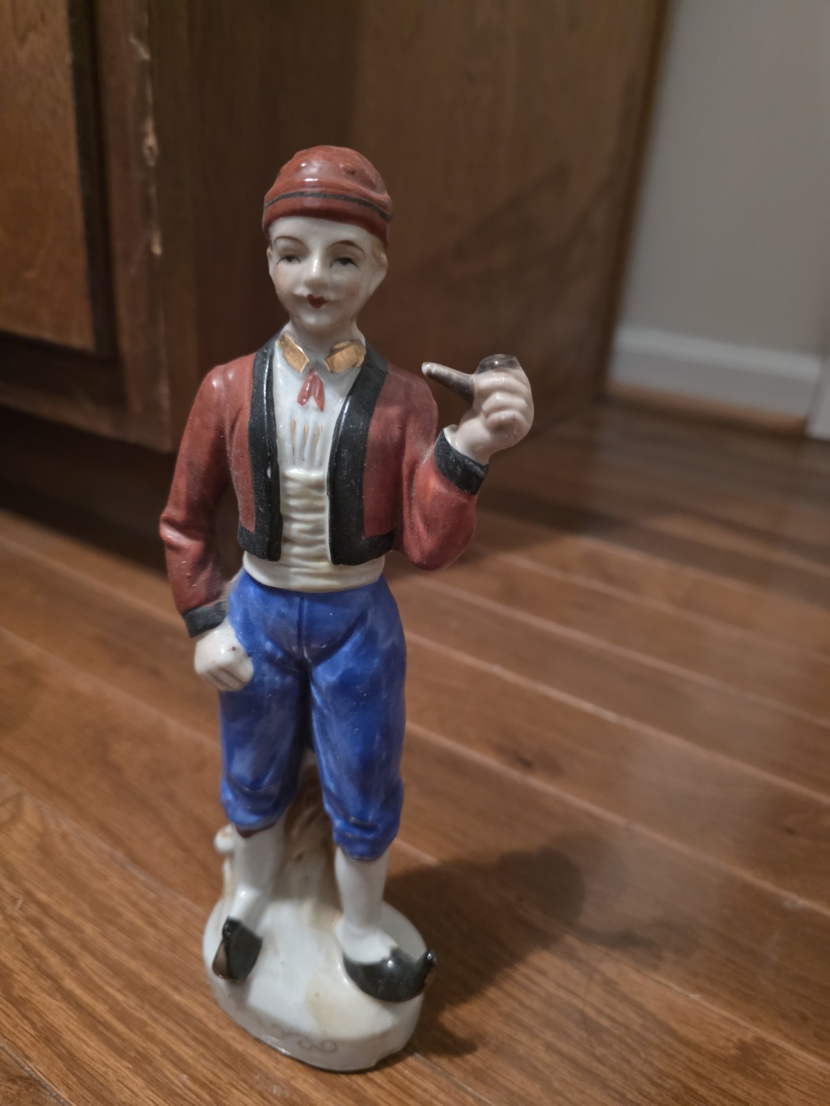 Vintage hand-painted ceramic figurine,  villager/peasant holding a pipe
