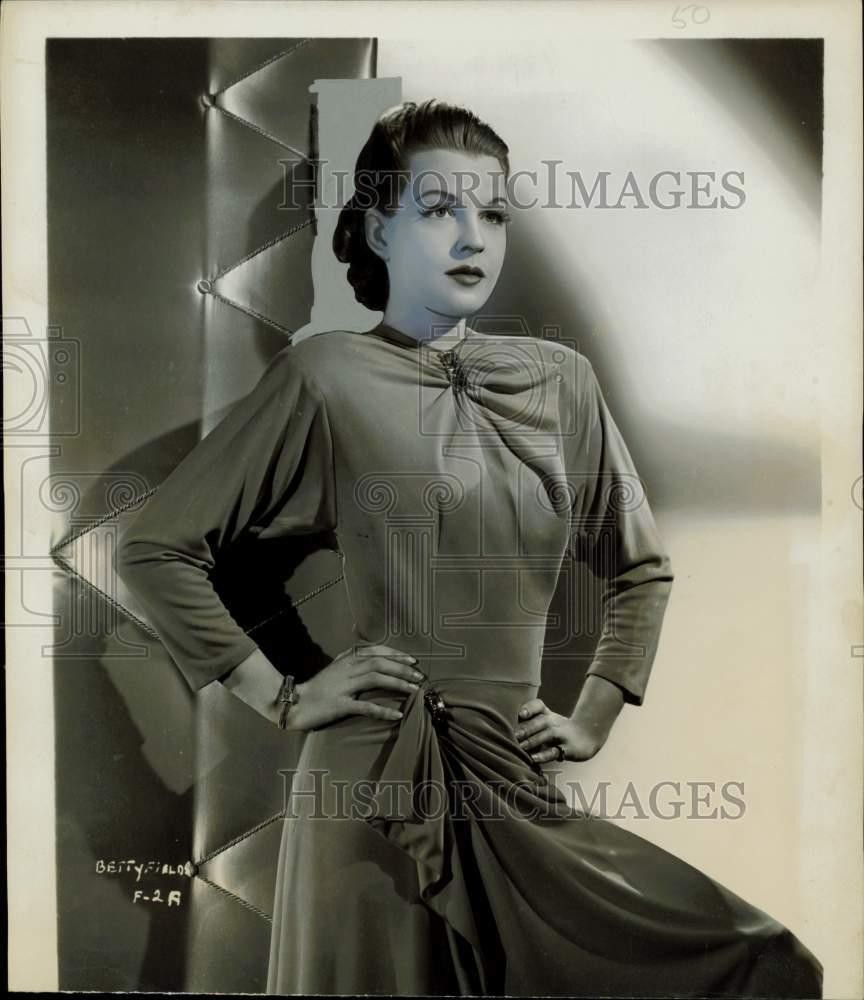 1944 Press Photo Actress Betty Field Models Orange Crepe Gown with Side Drapes