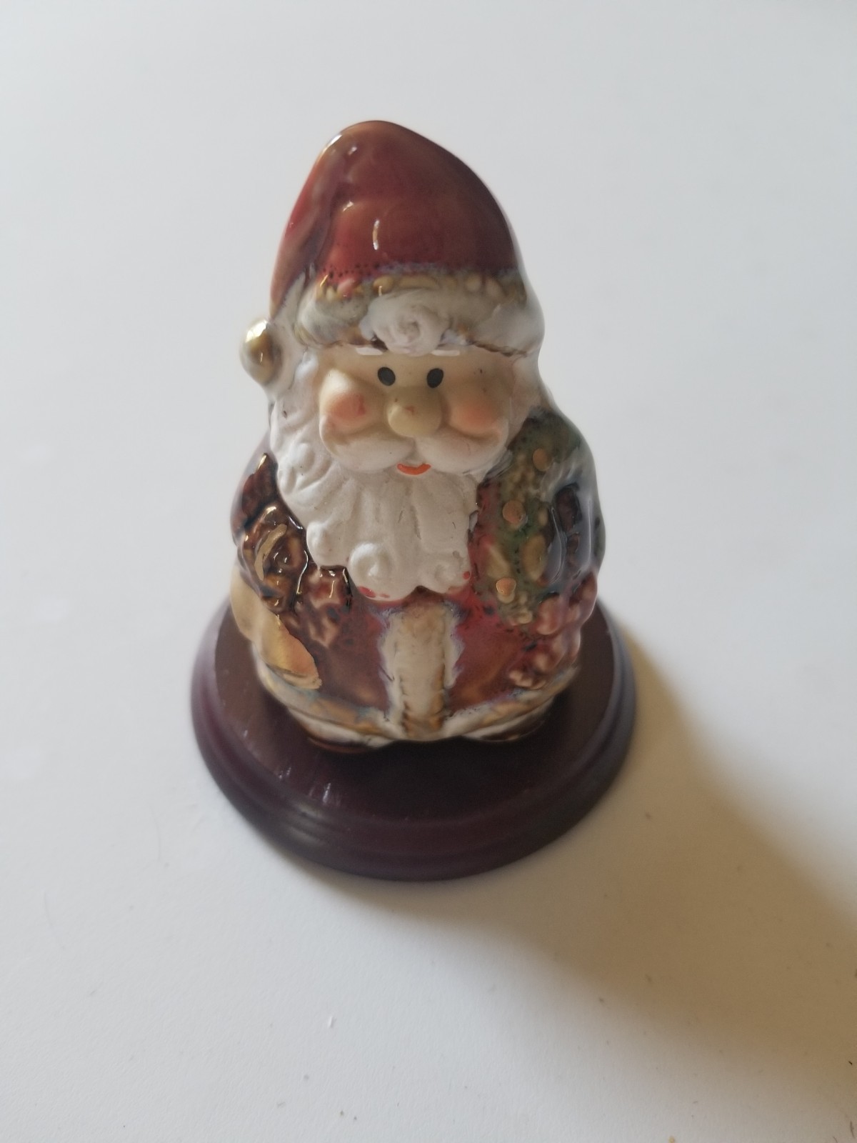 PREOWNED PORCELAIN SANTA CLAUS FIGURINE ON WOOD BASE 2.75\