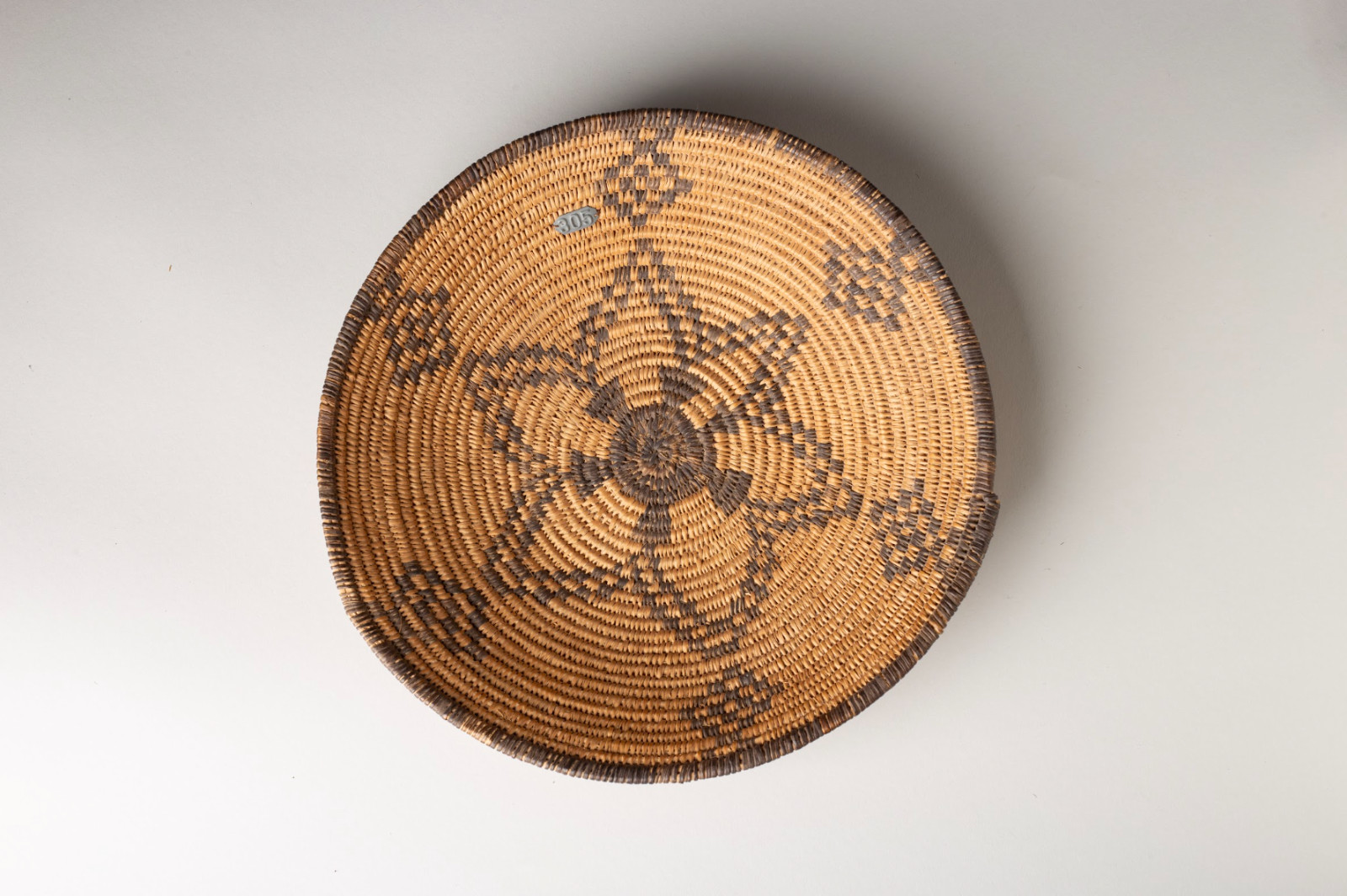 Apache Coiled Tray, Radiating Star Center Design, Metal Tag, Circa 1900 Apache Coiled Tray, Radiating Star Center Design, Metal Tag, Circa 1900