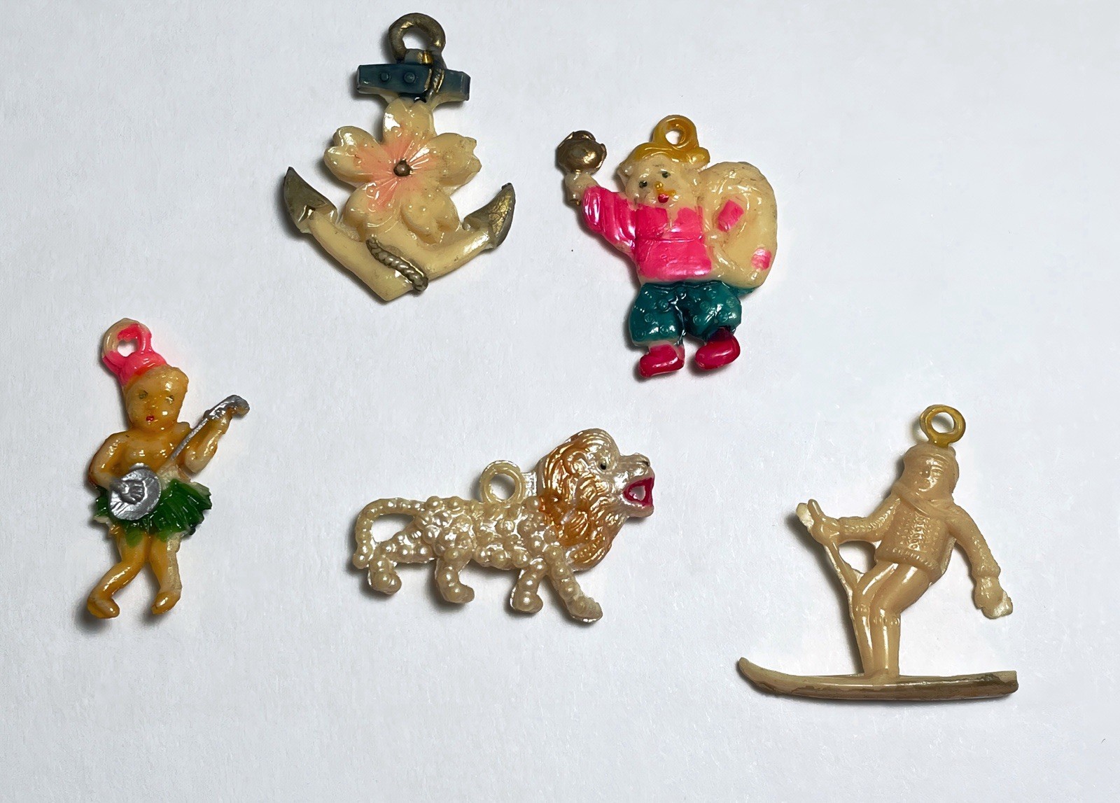 5 Celluloid 1940’s Cracker Jack Prize, Charm: Hula, Skier, Tiger, Anchor, Boy 5 Celluloid 1940’s Cracker Jack Prize, Charm: Hula, Skier, Tiger, Anchor, Boy