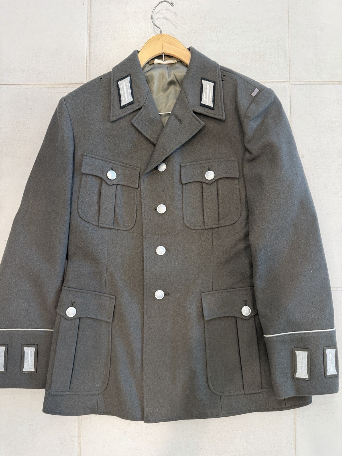 An authentic vintage East German (NVA/DDR) stone-gray military service tunic.