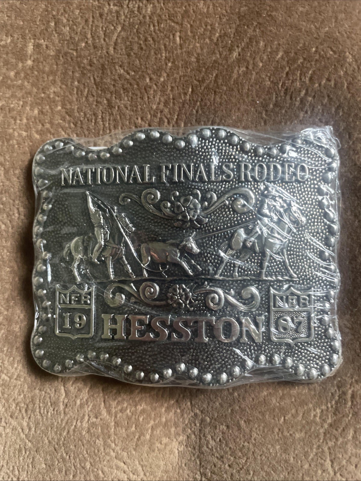 New In Wrapper - 1987 Hesston National Finals Rodeo Metal Belt Buckle 3 1/2”x3”
