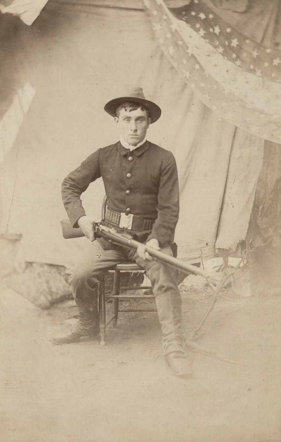 c. 1870's American Soldier Seated with Rifle, Star Banner in Back Photograph c. 1870's American Soldier Seated with Rifle, Star Banner in Back Photograph