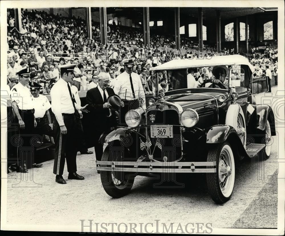 Press Photo An old time automobile arrives at a stadium  - net10631