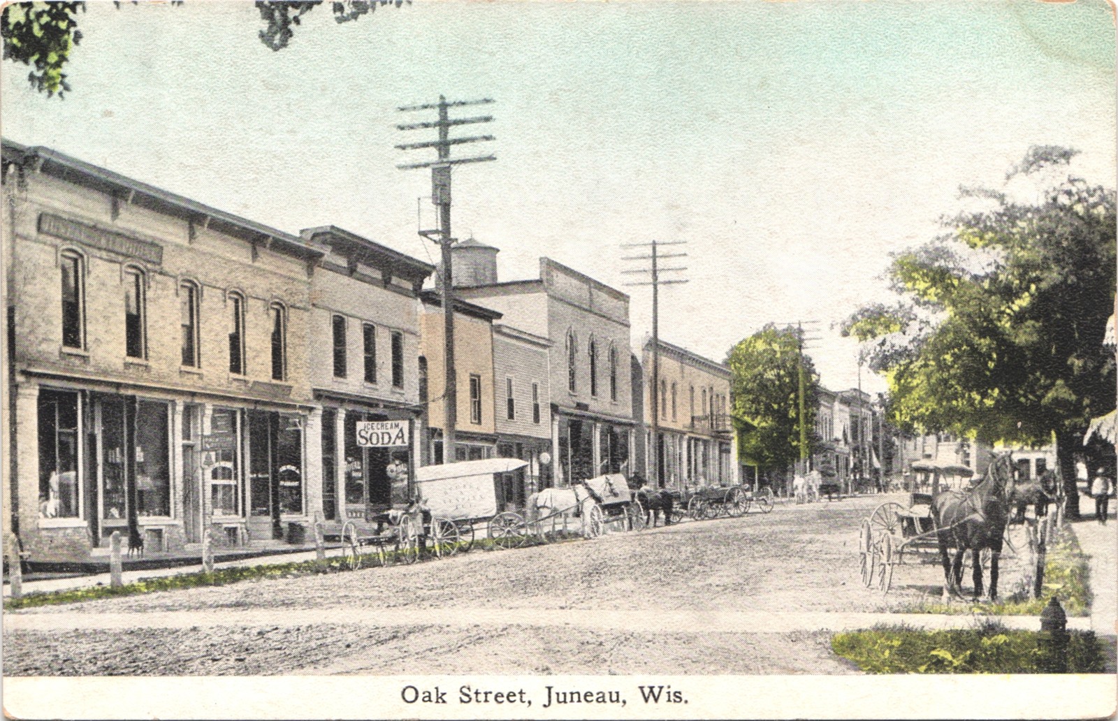 DOWNTOWN OAK STREET juneau wi c1910 postcard wisconsin historic scene shops