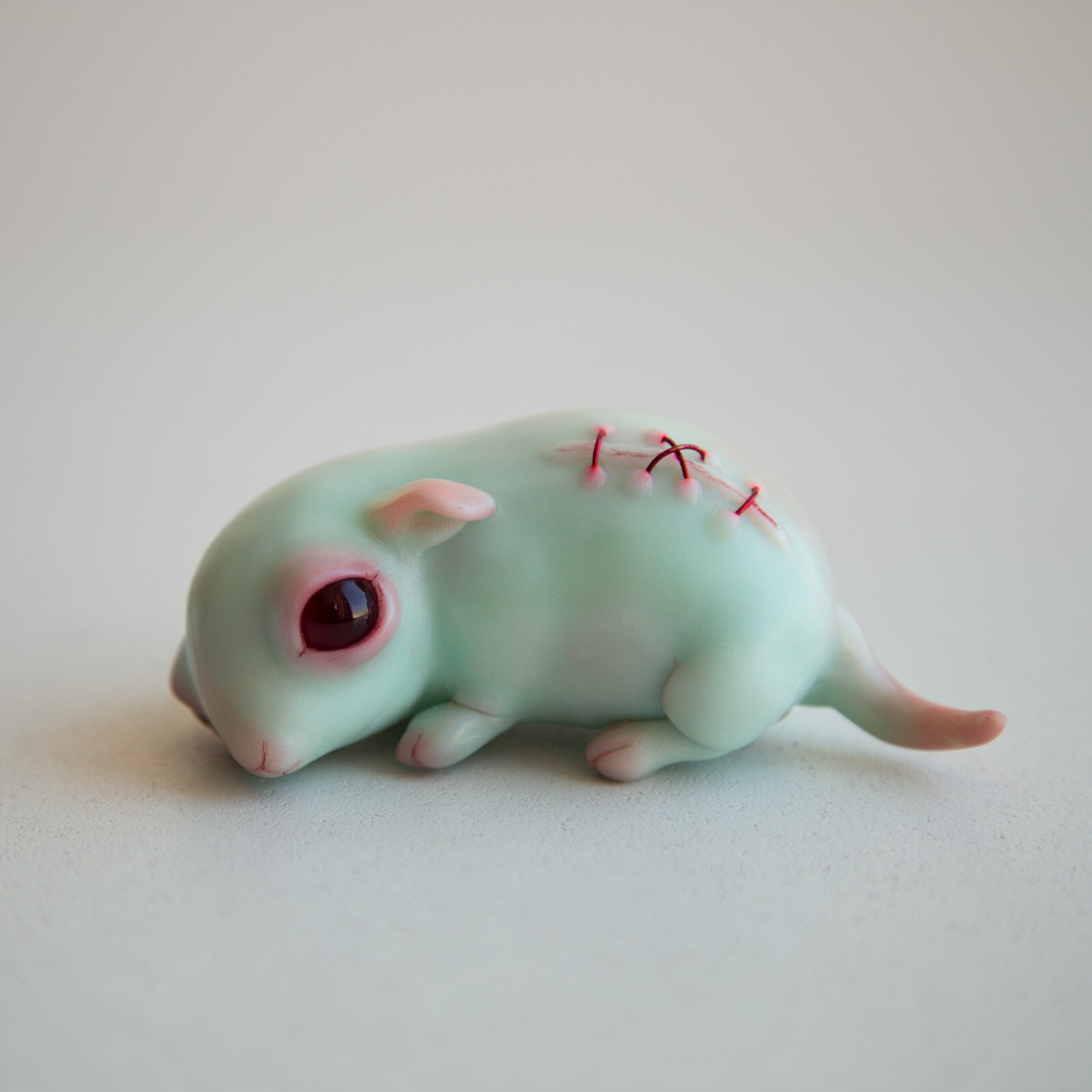 Turquoise weird sculpture of cute sad face minnie mouse