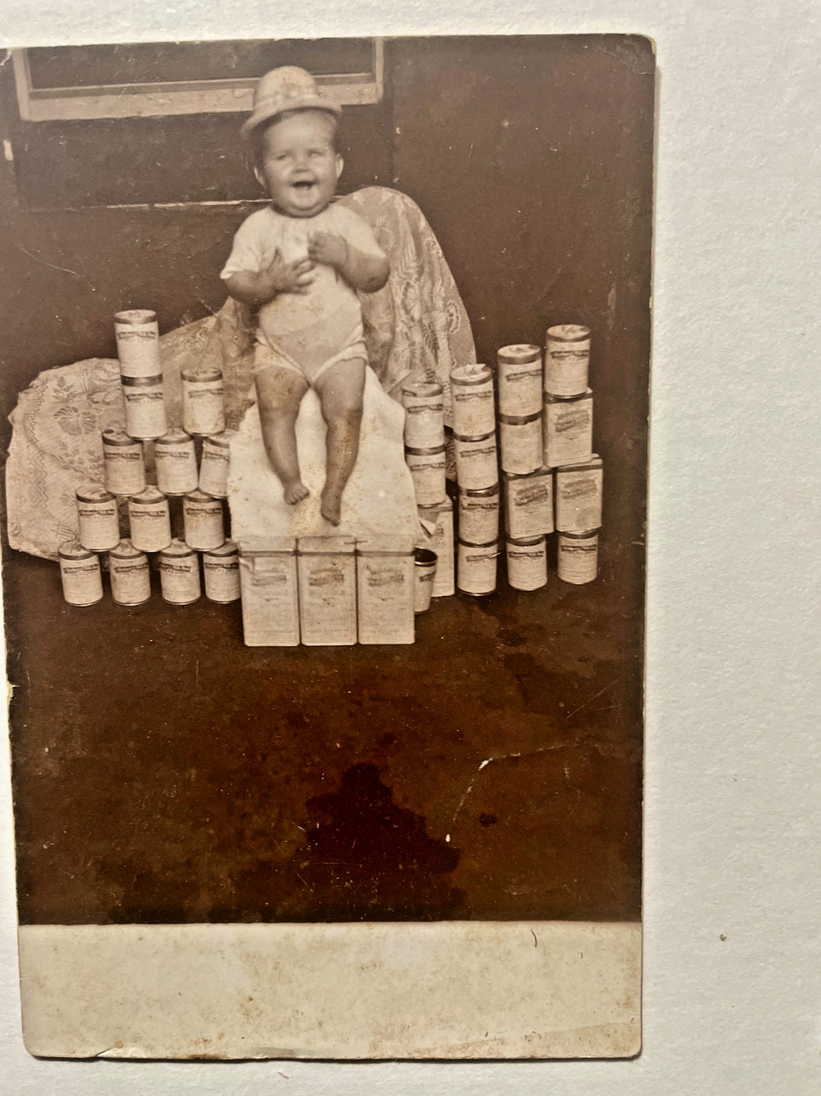 RPPC Scarce View of 8 month old Baby Sitting on Canned-Goods c.1910
