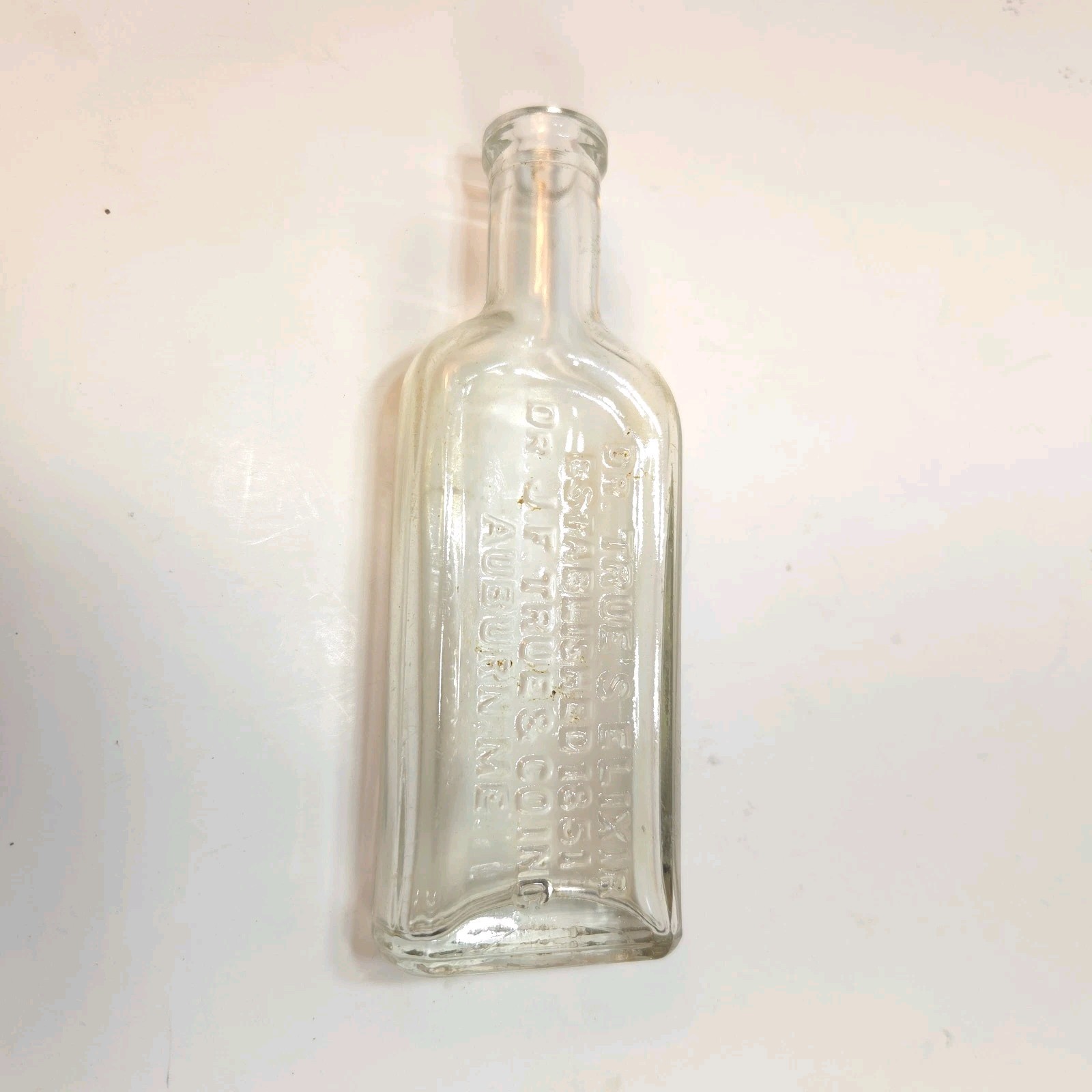 vintage clear glass medicine bottle embossed with the text DR. TRUE\'S ELIXIR