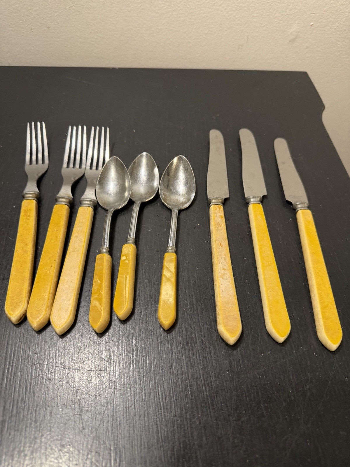 Vintage 9-piece stainless steel flatware lot with yellow Bakelite handles Vintage 9-piece stainless steel flatware lot with yellow Bakelite handles