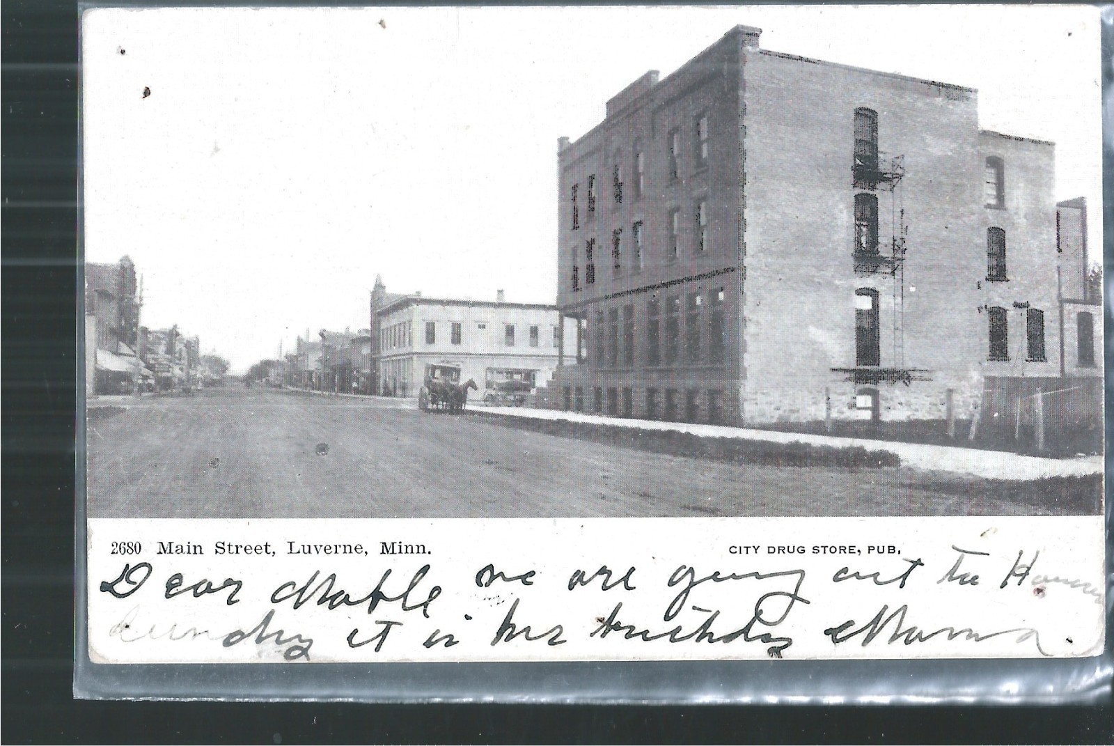 NICE EARLY VIEW OF HORSE AND WAGON ON MAIN ST IN LUVERNE, MN 1907