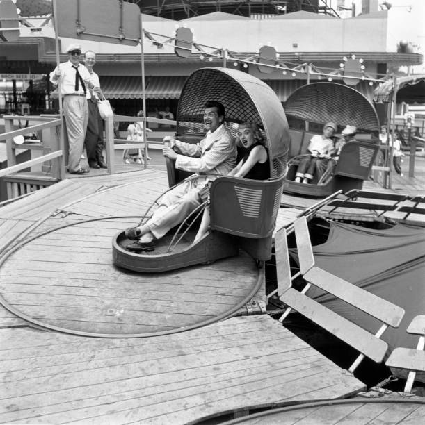 Comedian Ernie Kovacs rides Tilt A Whirl an expression mock t- 1950 Old Photo
