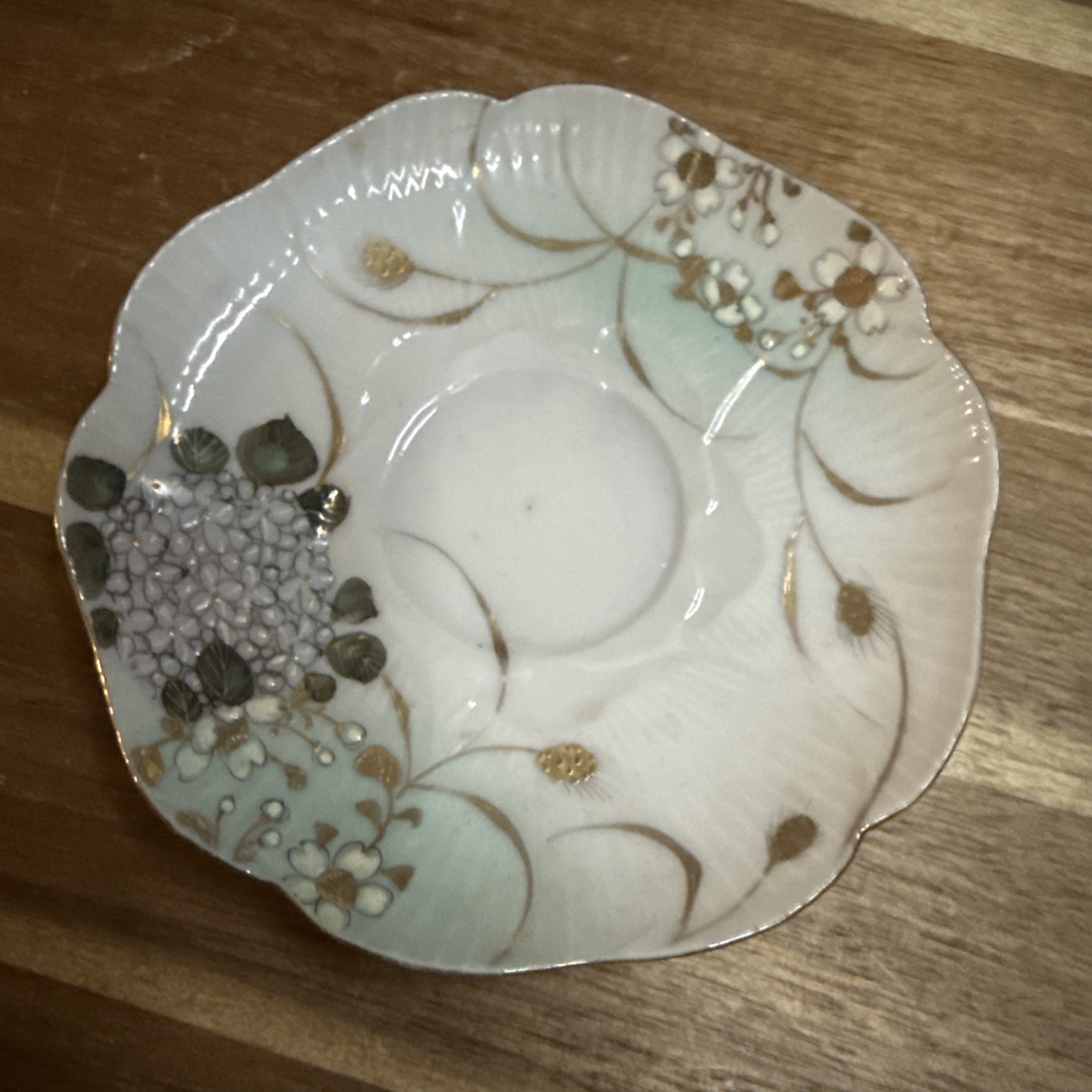 vintage bone china teacup saucer with a hand-painted gold floral design vintage bone china teacup saucer with a hand-painted gold floral design