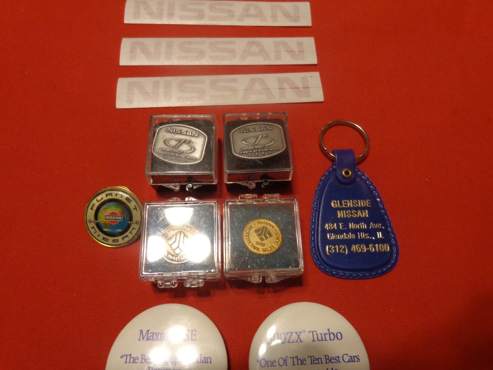 VINTAGE 11 PIECE NISSAN MOTORS ADVERTISING & EMPLOYEE AWARDS-  NEVER USED  # 502