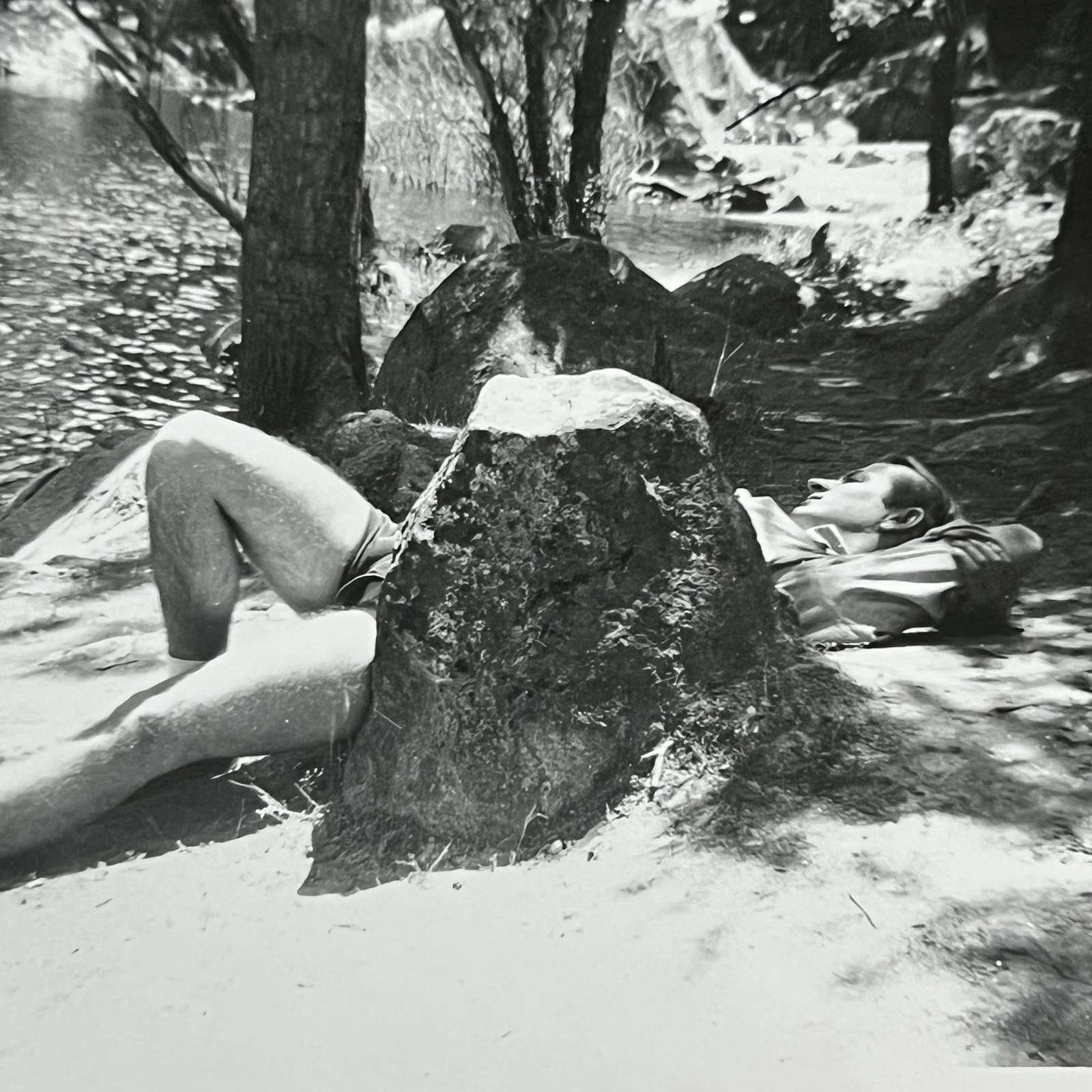Vintage B&W Snapshot Photograph Handsome Man Laying Outside Behind Rock Shorts Vintage B&W Snapshot Photograph Handsome Man Laying Outside Behind Rock Shorts