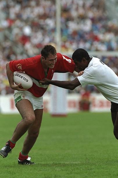 Emyr Lewis of Welsh Presidents Seven pushes off a tackle Hong Kong- Old Photo