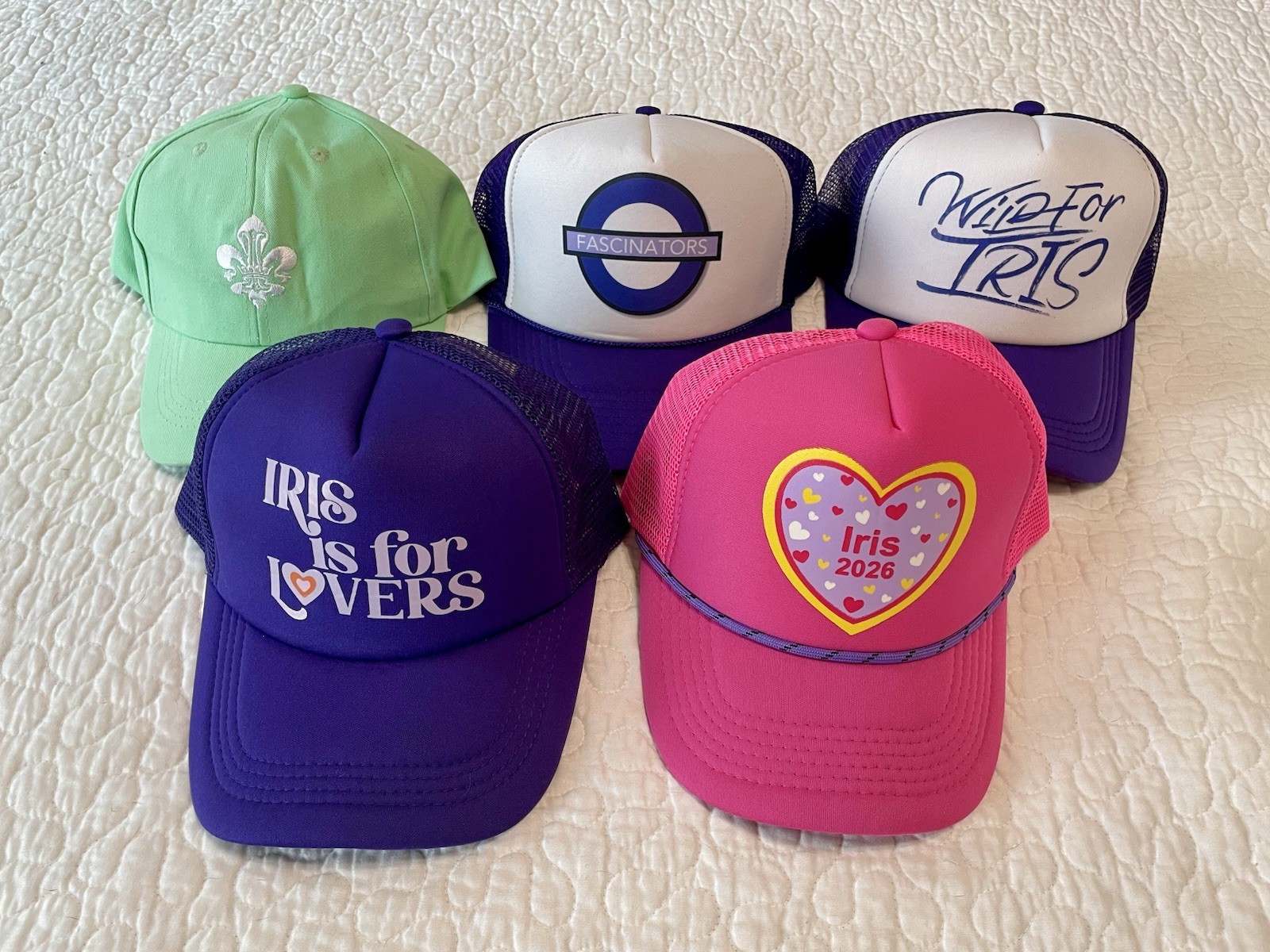 5 Krewe of Iris Mardi Gras hats including “Iris is for Lovers” and “Iris 2026” 