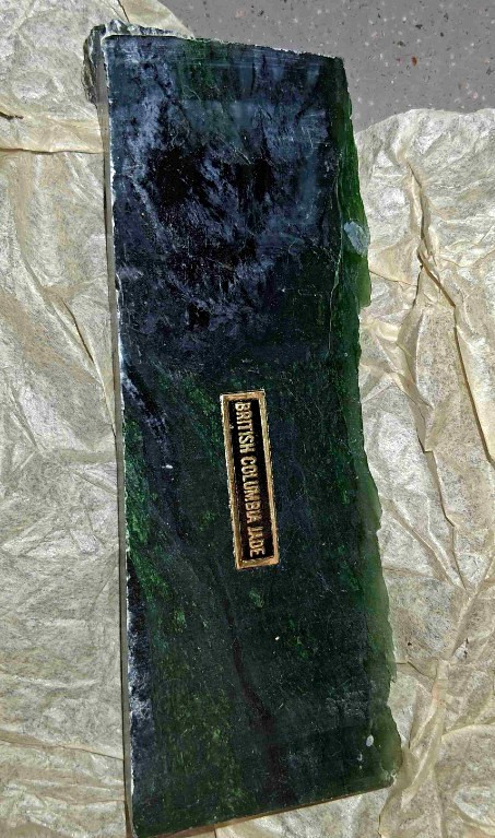A raw slab of dark green British Columbia nephrite jade.