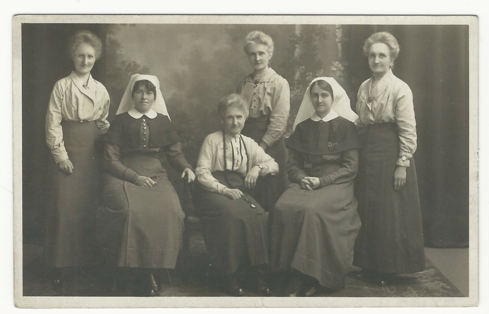 PORTRAIT OF FOUR OLDER WOMEN AND TWO YOUNG (NUNS?) OR (NURSES?)