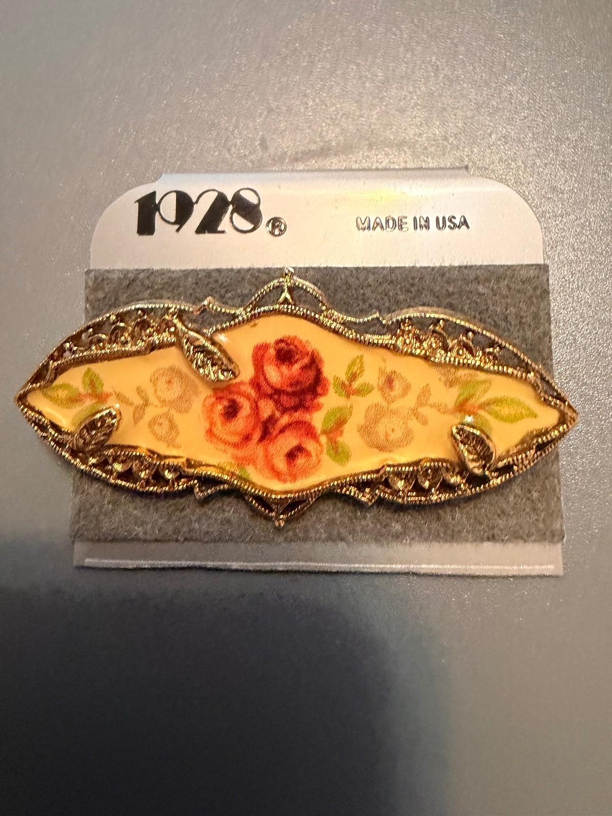 Vintage 1928 Floral Gold Tone pin in original packaging