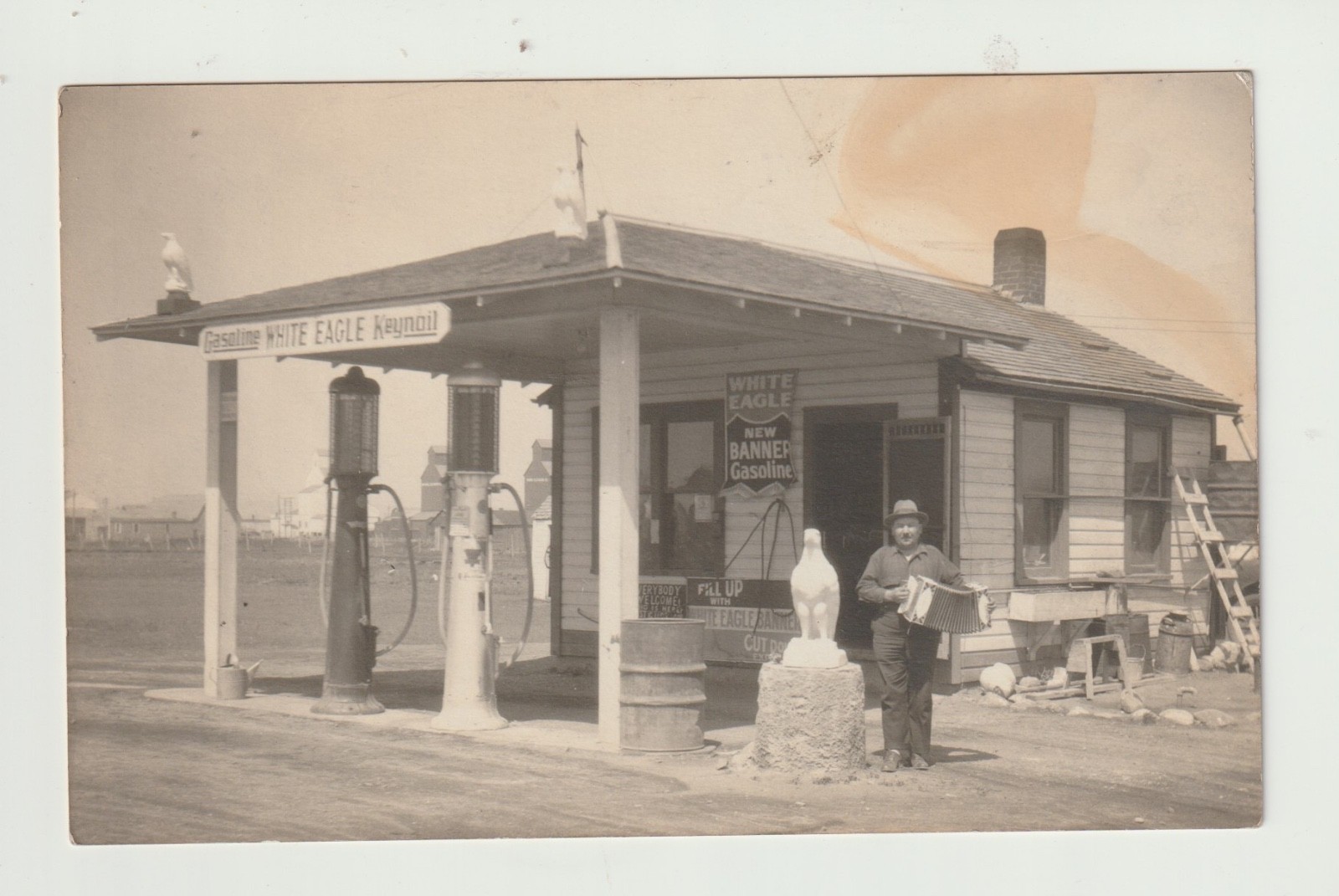 Vintage RPPC: WHITE EAGLE GASOLINE STATION, OWNER PLAYING ACCORDION
