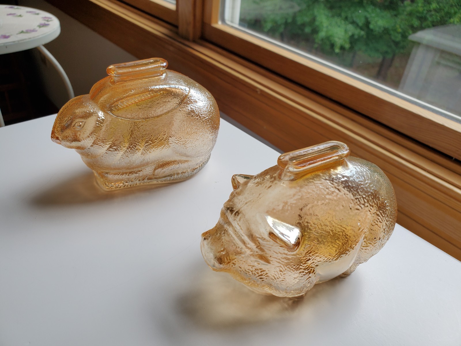 Vintage light amber glass bunny / rabbit bank and a piggy bank