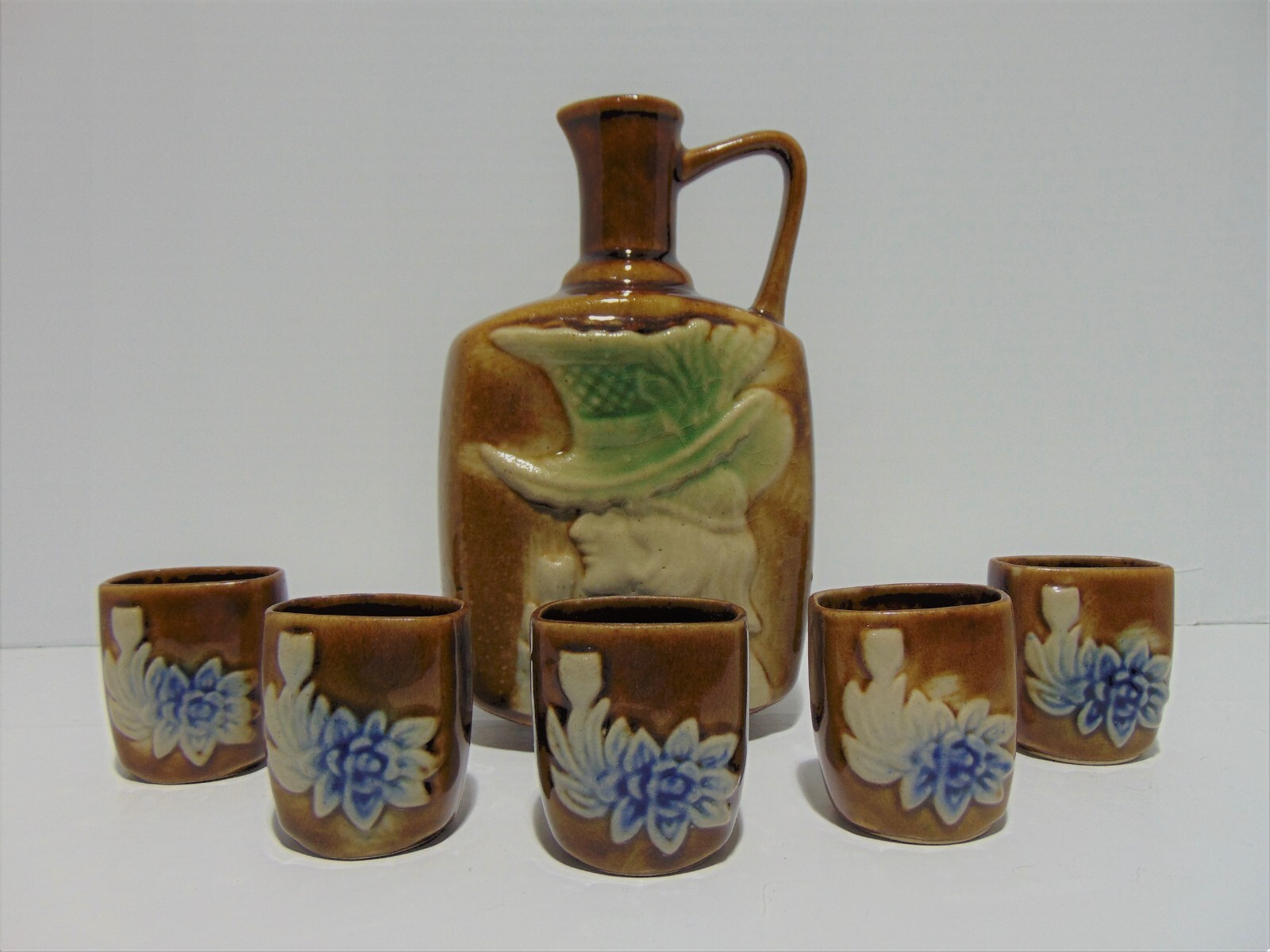 Brown Pottery Sake Alcohol Decanter With 5 Cups Woman In Hat Floral Brown Pottery Sake Alcohol Decanter With 5 Cups Woman In Hat Floral