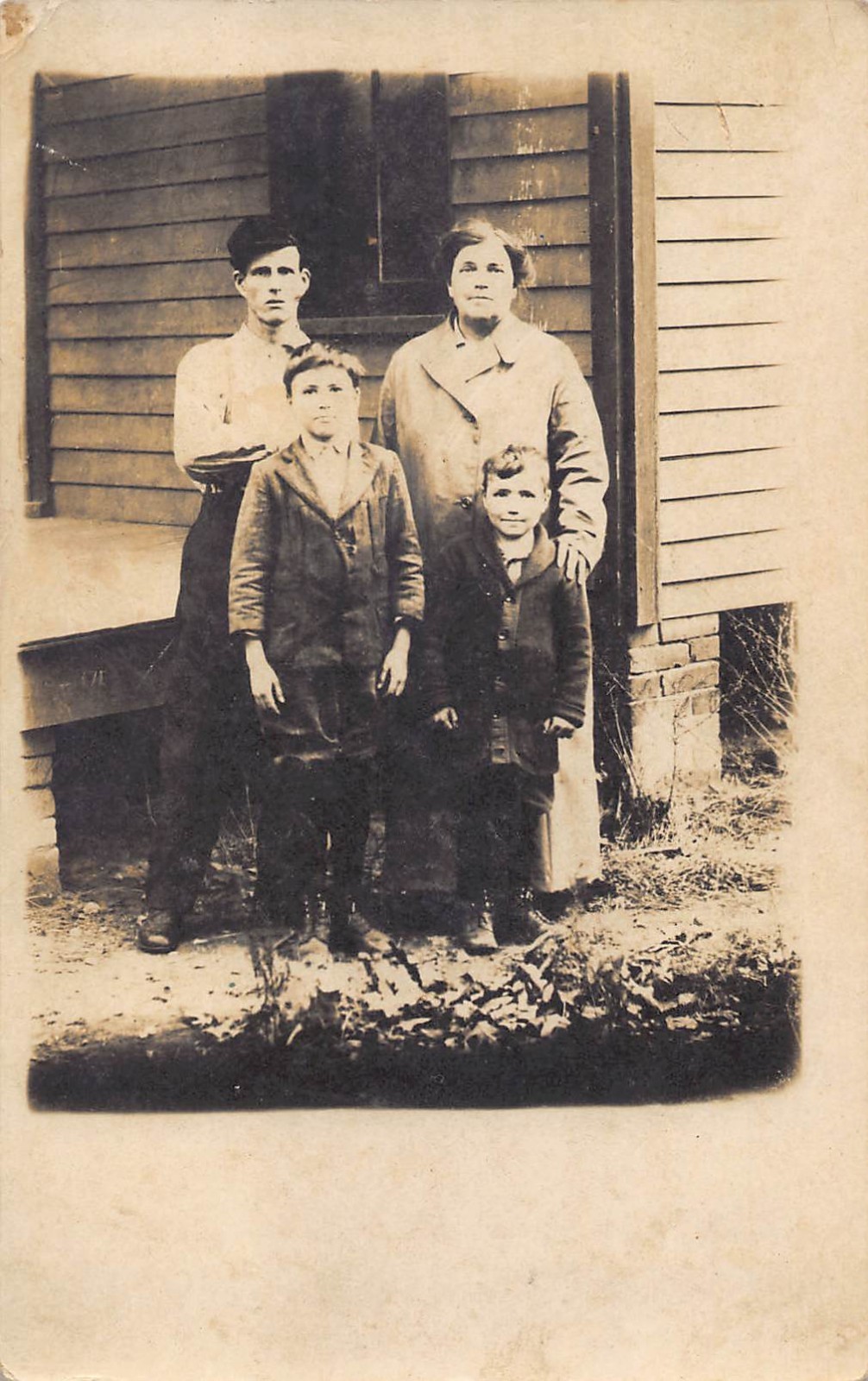 RPPC Tough Man Woman Kids Family Porch 1910s Postcard Housecoat Bricks Rustic