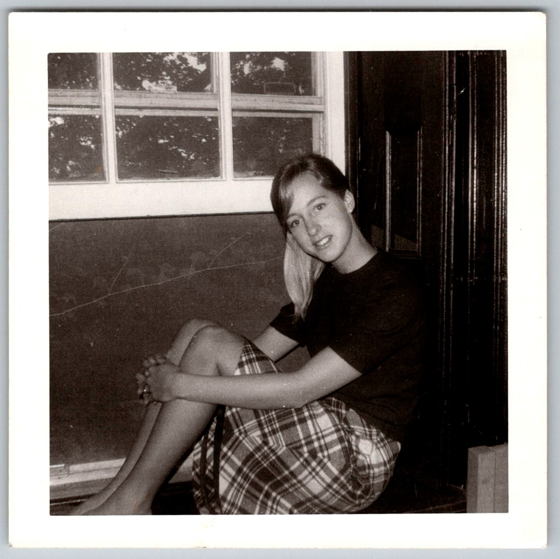 Vtg B&W Snapshot Pretty Young Woman Plaid Skirt Sitting Window 1960s