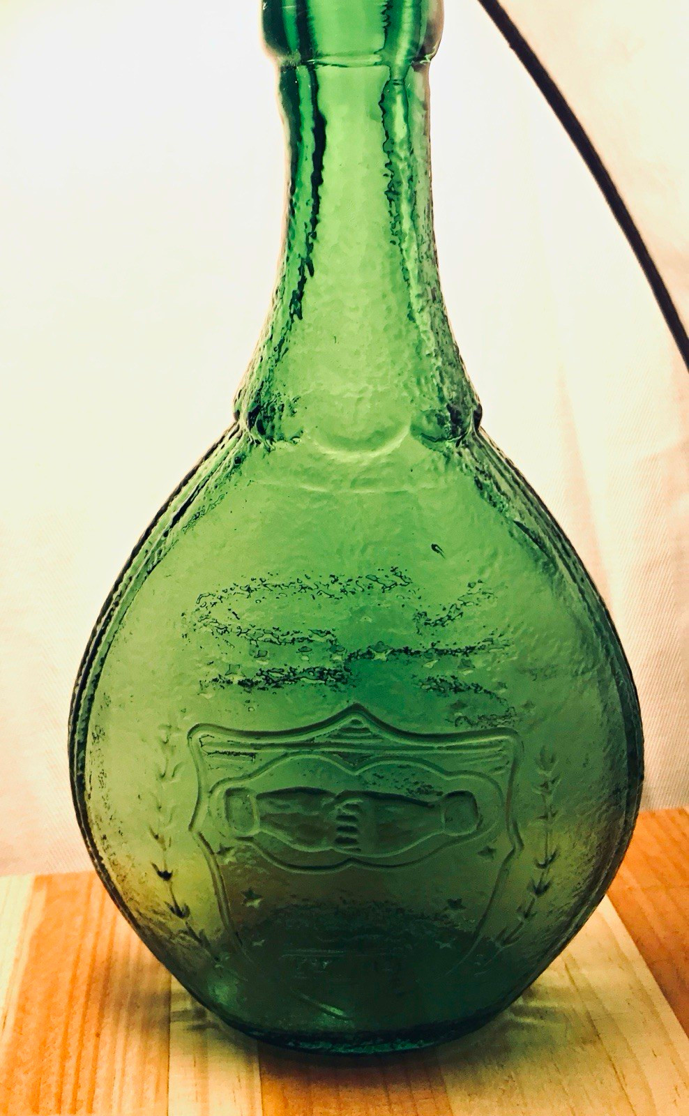Vintage Green Glass Decanter Bottle, Flask-Style, Embossed Shield Design. Vintage Green Glass Decanter Bottle, Flask-Style, Embossed Shield Design.