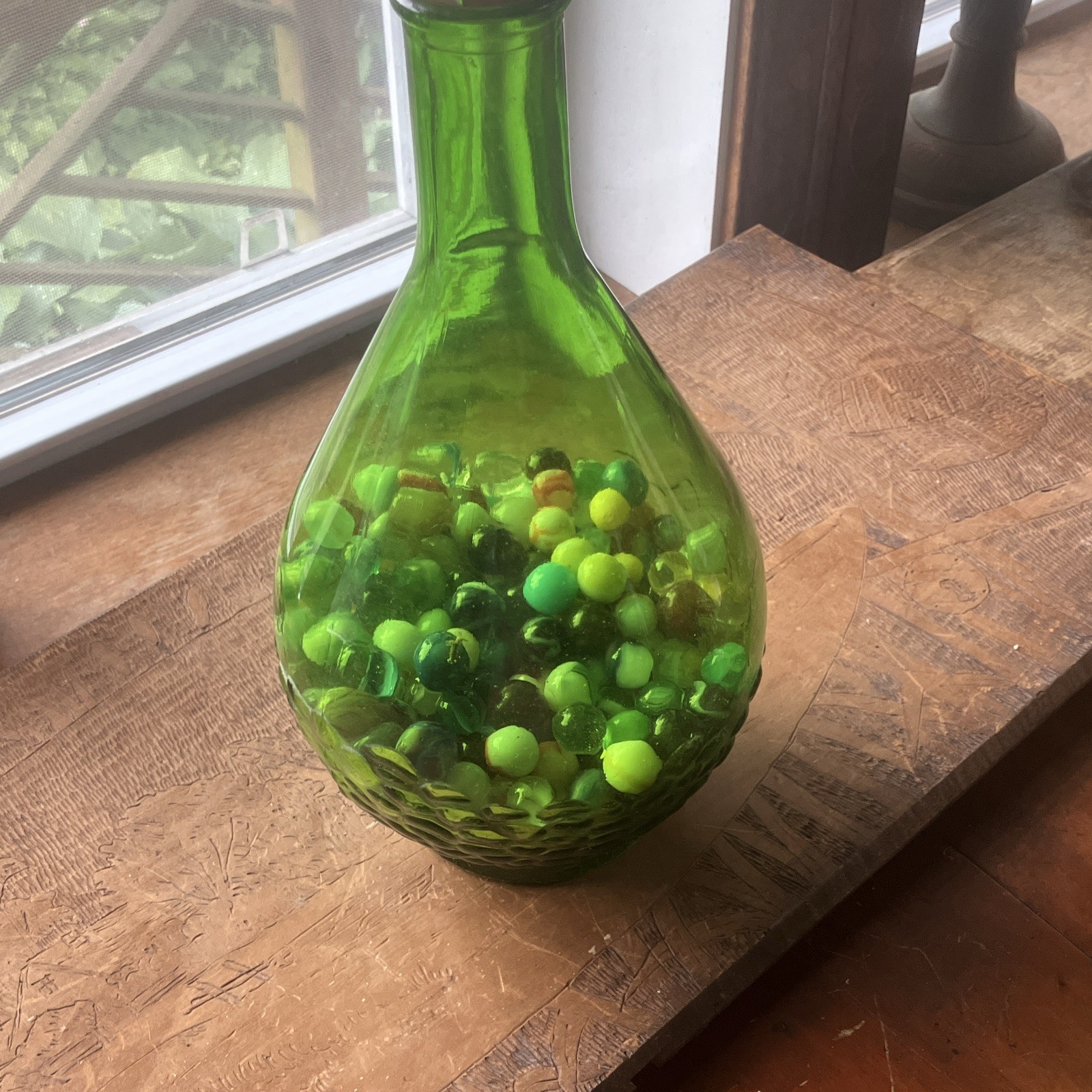 Green  Glass Wine Bottle with Cap, Filled with Assorted vintage Marbles Inside