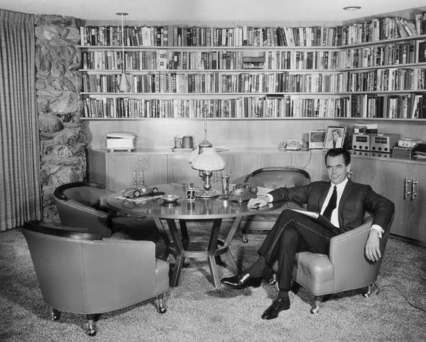 Canadian actor Glenn Ford sits a chair study home Beverly Hills Ca- Old Photo