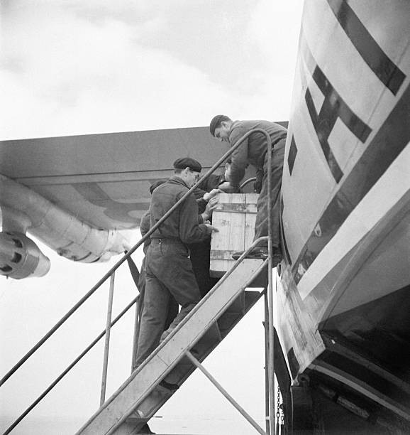 Personnel loading parcels luggage into hold of an aircraft Marigna- Old Photo 1