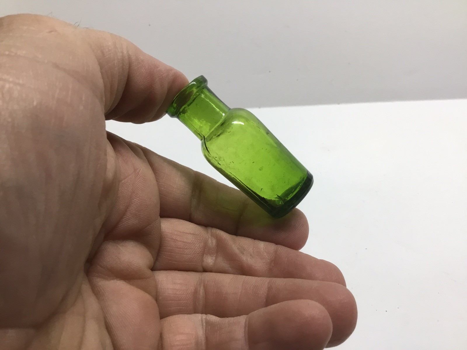 Small Round Antique Bright Green Medicine Bottle. 2 1/8 Inches Tall.
