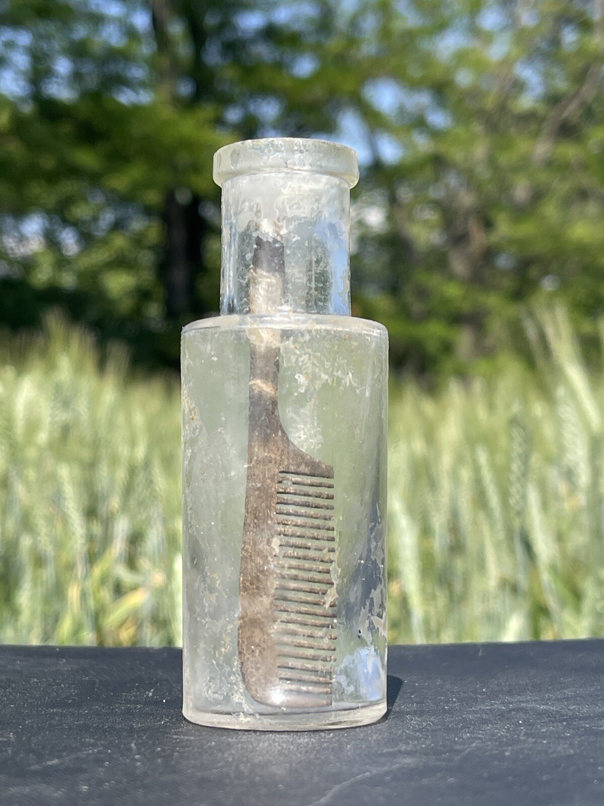 Pre-1900s Antique cosmetic glass bottle with comb inside
