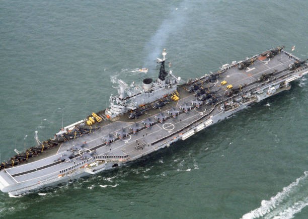 An aerial view of the aircraft carrier HMS Hermes its deck lined b- Old Photo