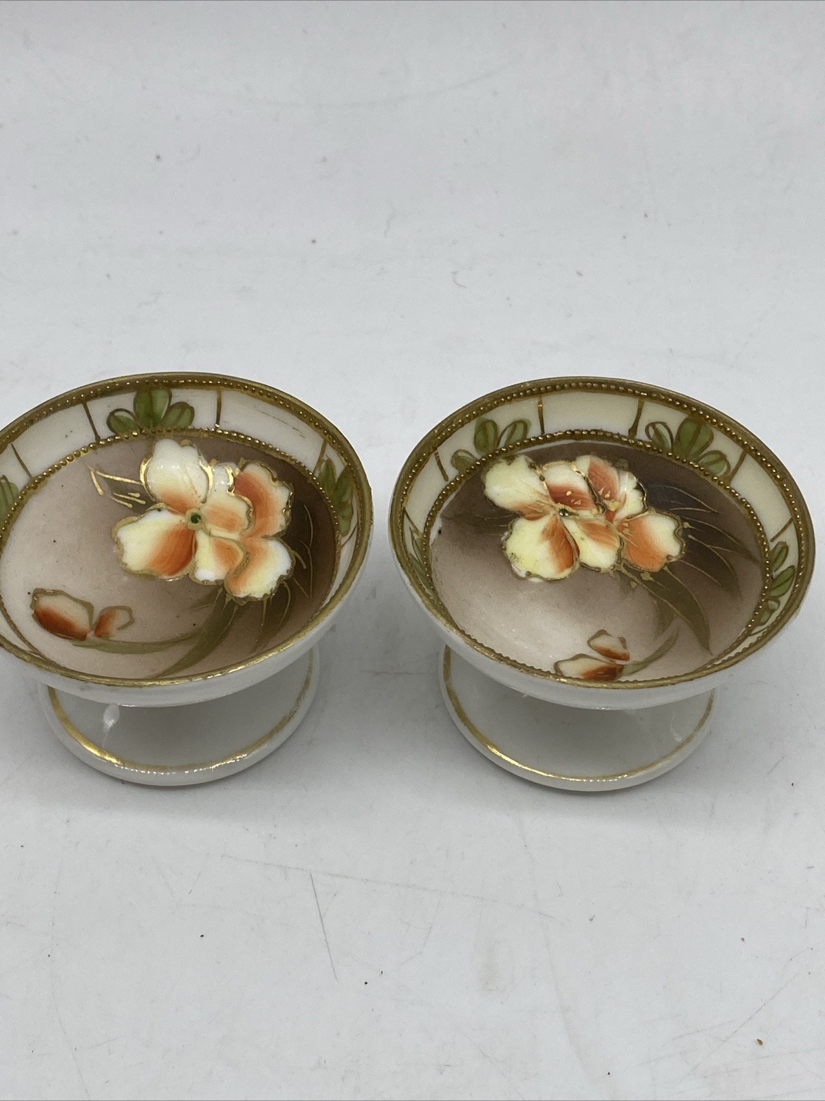 TWO VINTAGE NIPPON HAND PAINTED FLORAL FOOTED SALTS - JAPAN