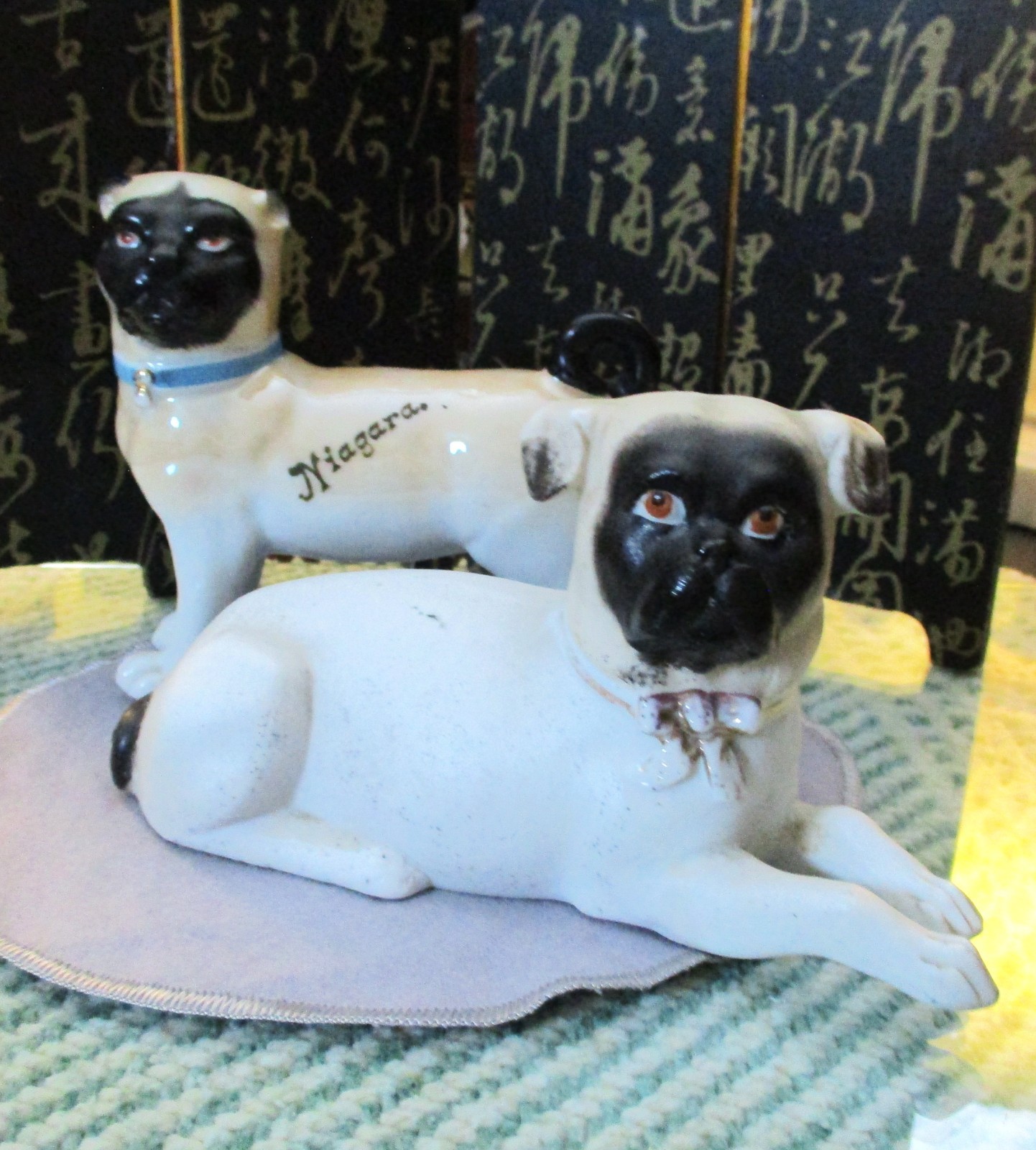 TWO ANTIQUE PORCELAIN *PROBABLY GERMAN* PUG DOGS* 1 - 5 IN. LONG* 1 -7 IN. LONG TWO ANTIQUE PORCELAIN *PROBABLY GERMAN* PUG DOGS* 1 - 5 IN. LONG* 1 -7 IN. LONG