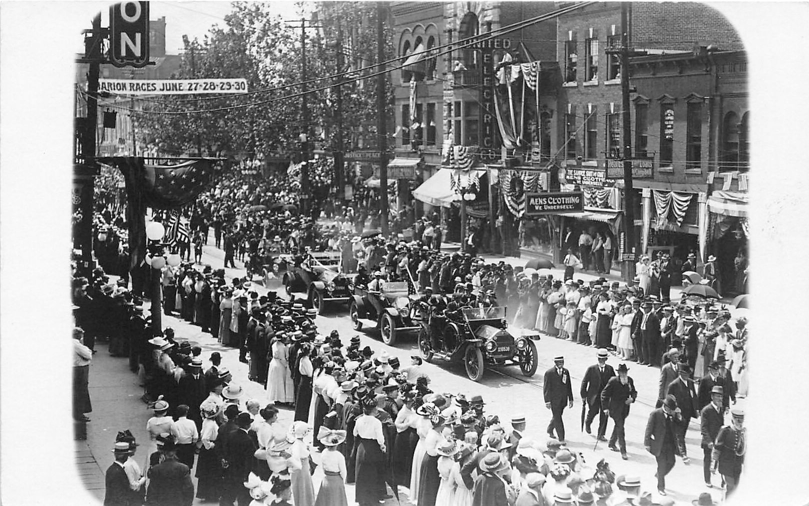 H91/ Marion Indiana RPPC Postcard c1910 Parade Crowd Automobiles Stores 156