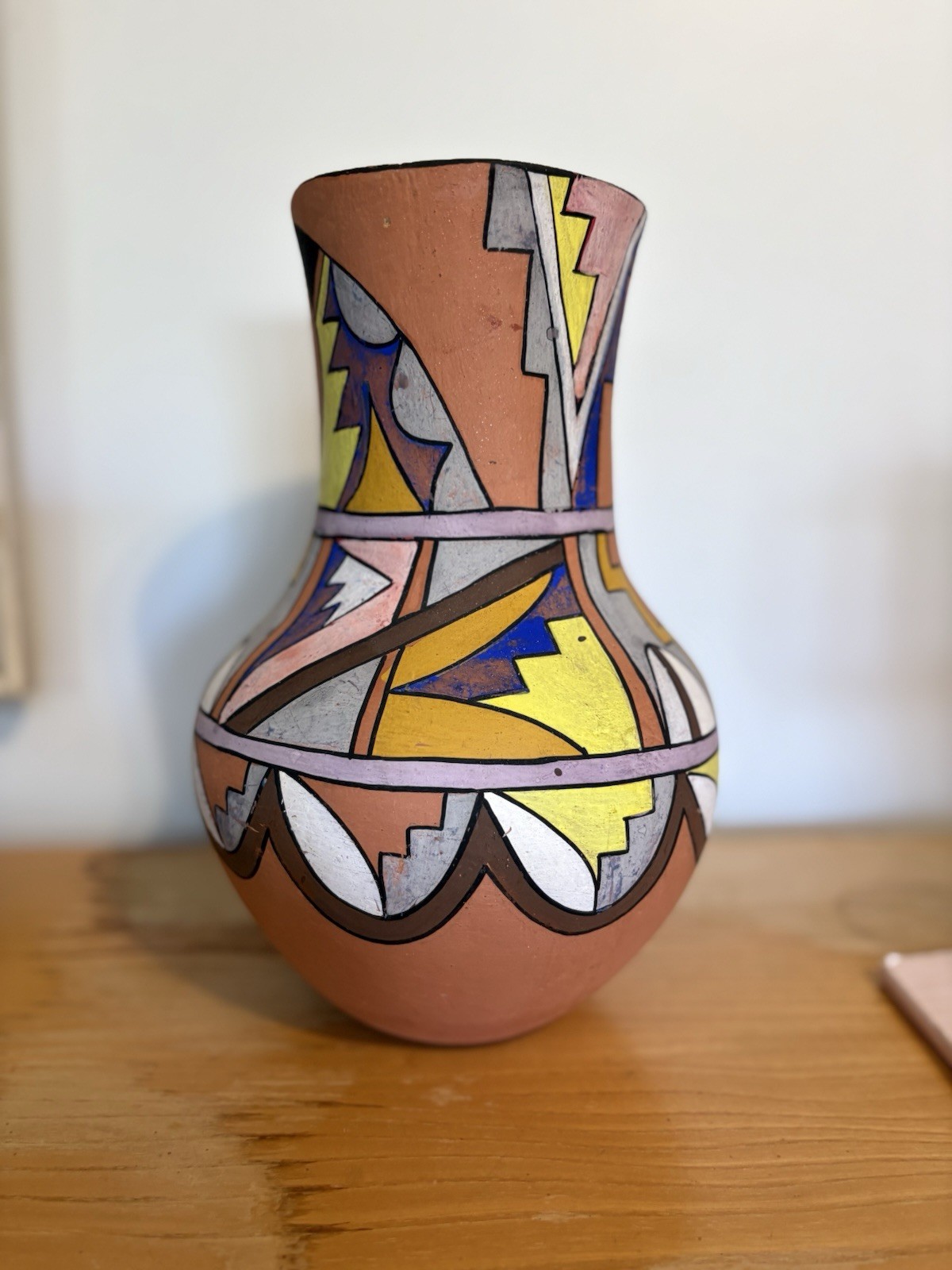 Vintage Jemez Pueblo polychrome ceramic vase with geometric painted designs.