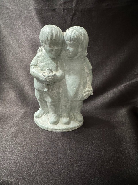 statue of a boy and girl with frog