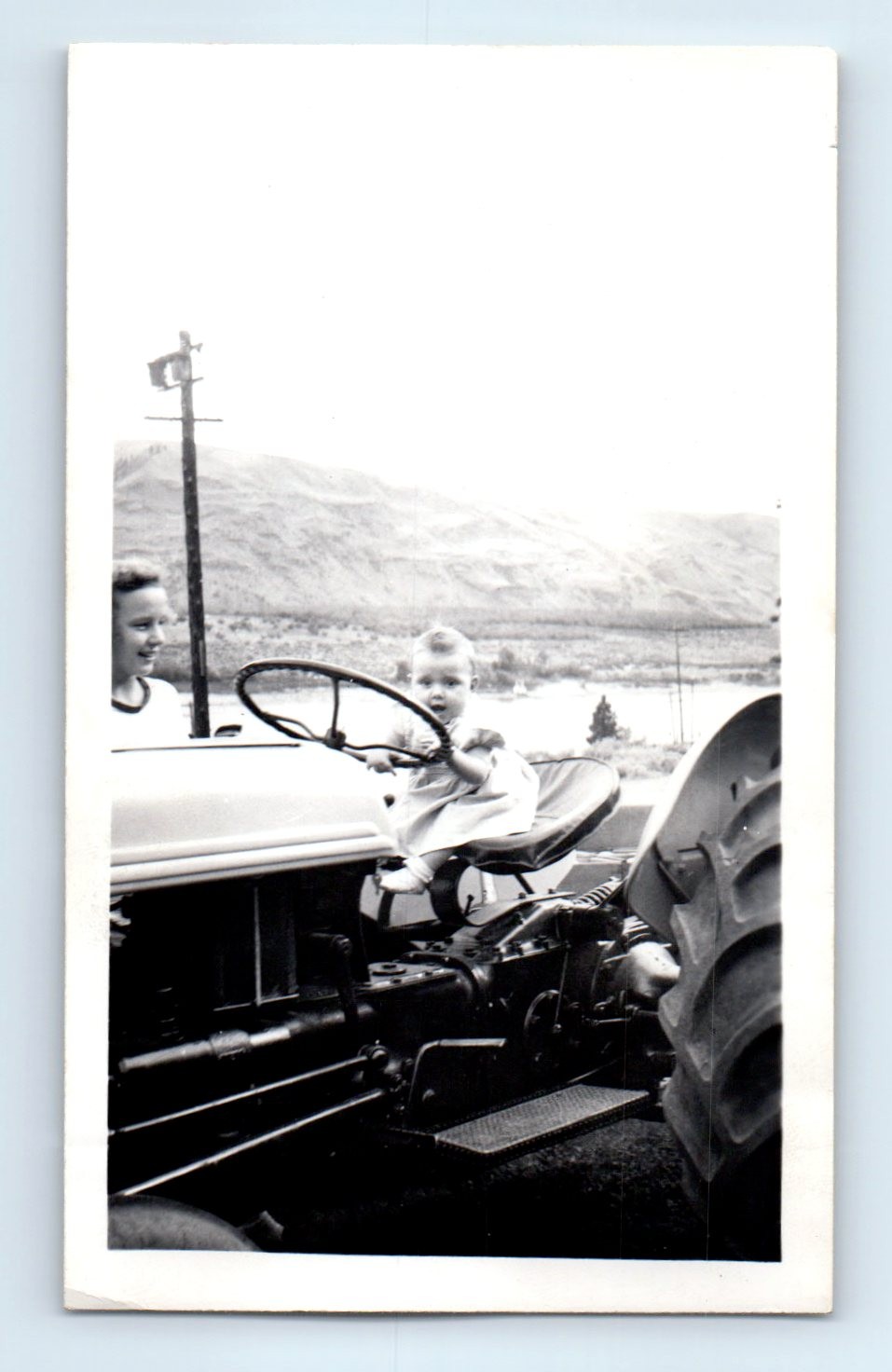 Old Vintage Photo WOMAN AND BABY DRIVING FARM TRACTOR FUNNY HUMOROUS SNAPSHOT