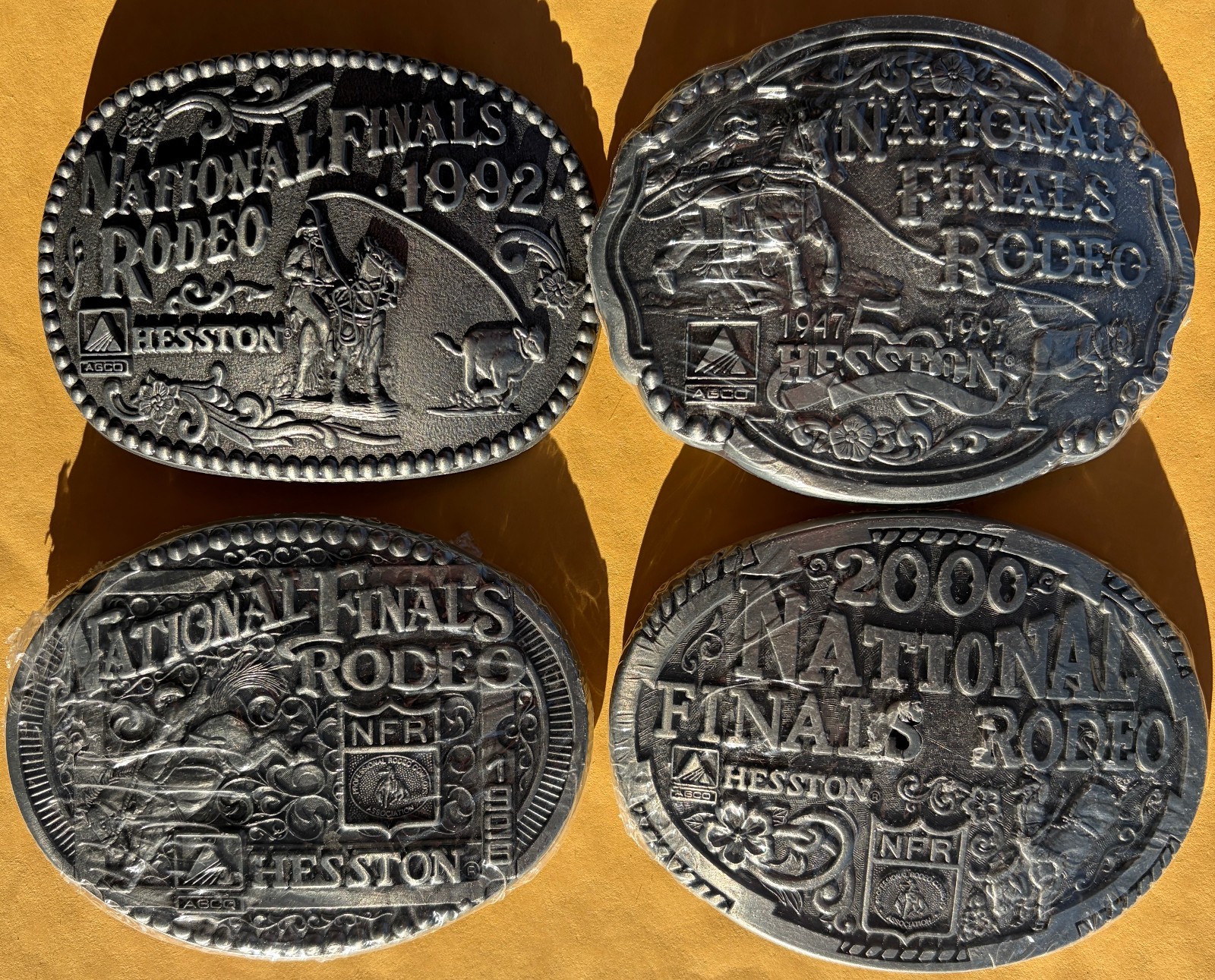 Lot of 4 1992-2000 Hesston National Finals Rodeo Adult Belt Buckles