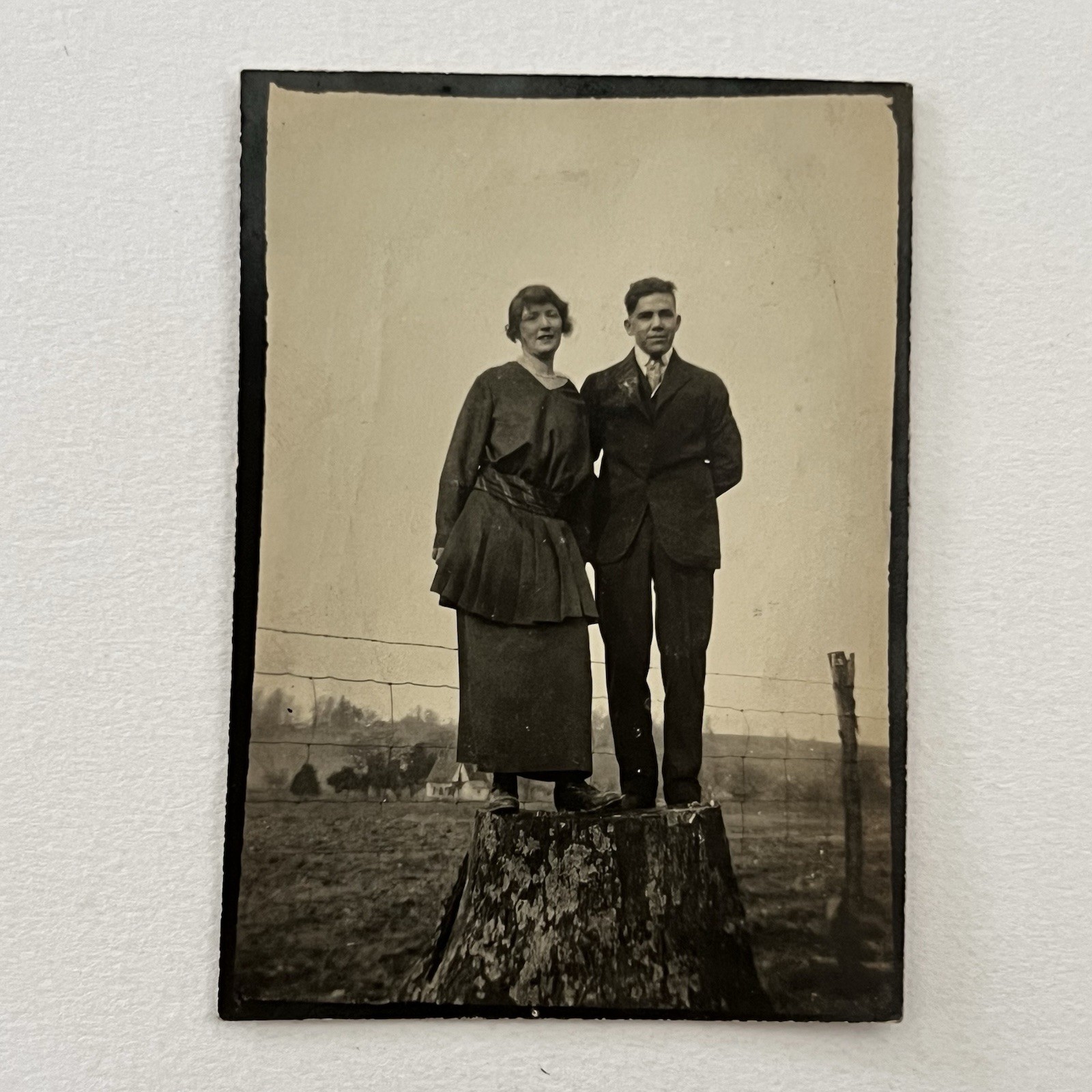 Antique Sepia Snapshot Photograph Young Couple Standing On Tree Stump On Farm