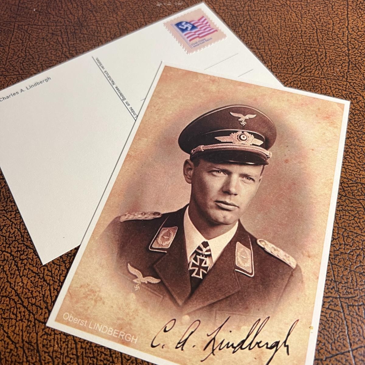Charles Lindbergh in Luftwaffe Uniform - autographed postcard + unique postage