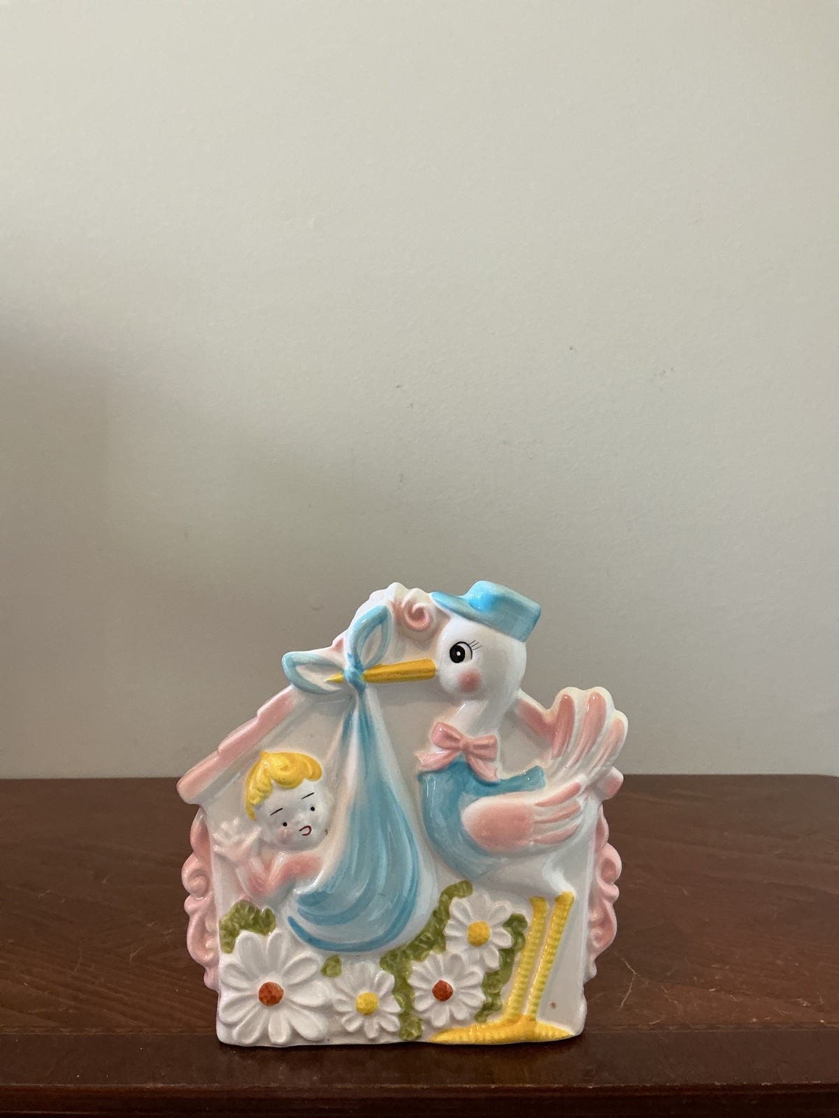 vintage ceramic stork and baby nursery planter, often produced in mid-century 