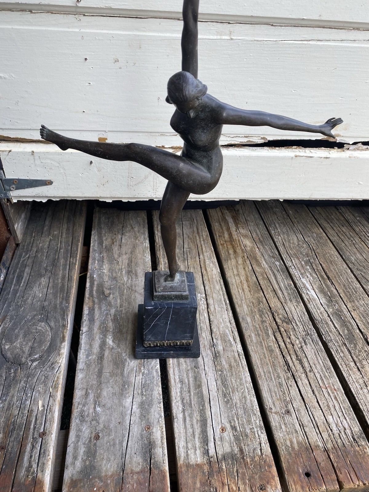 Art Deco bronze sculpture,  female dancer dynamic arabesque pose.