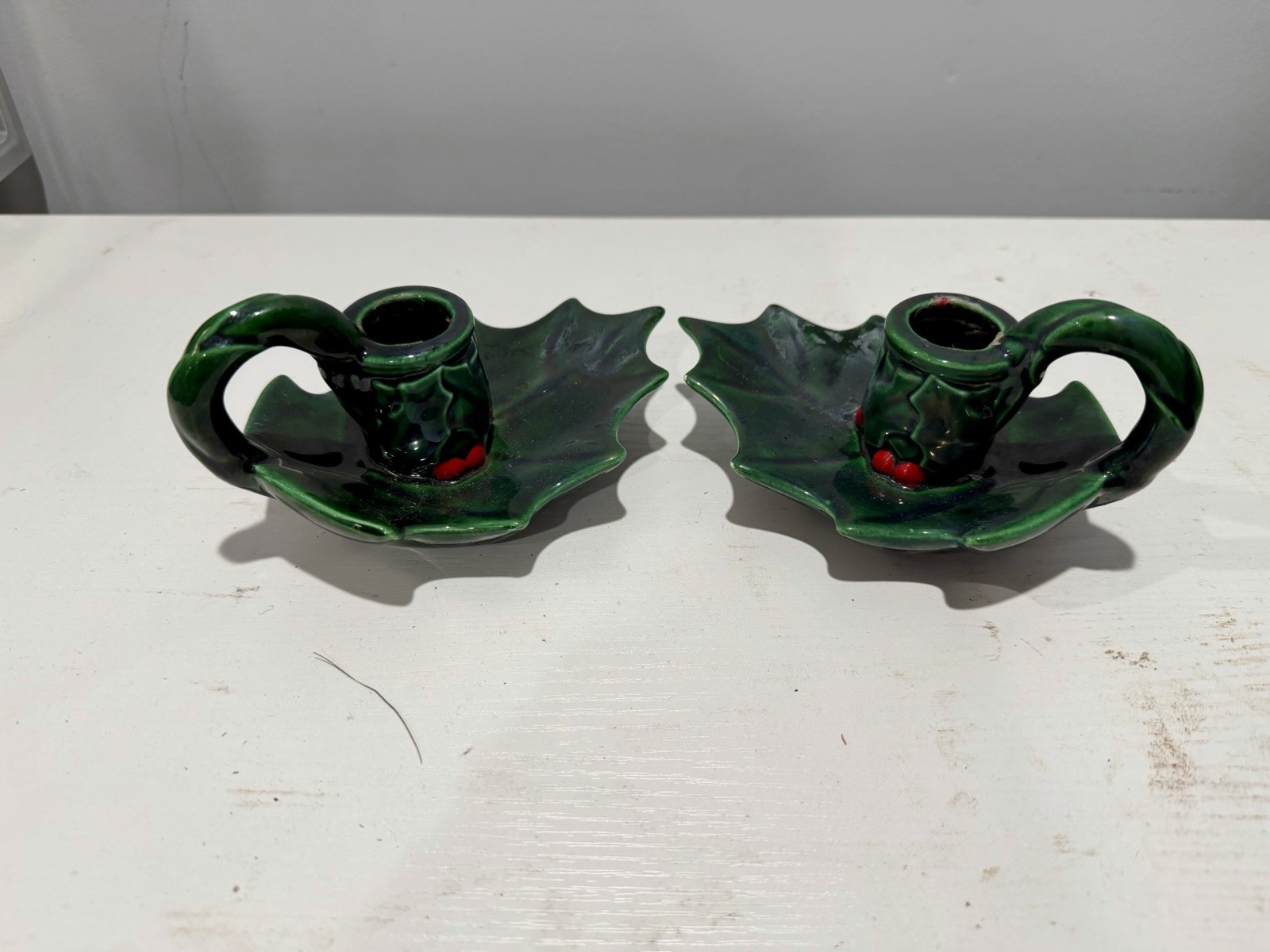 Pair of Vintage glossy green ceramic holly leaf finger-loop candlestick holders