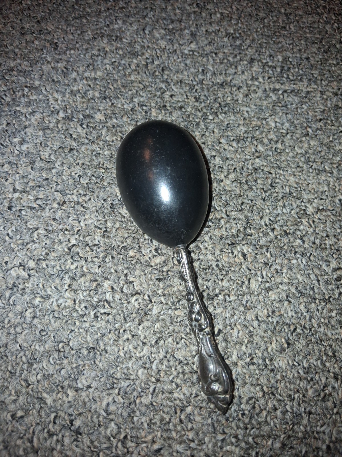 Victorian sock darning egg, ebony wood body and sterling silver handle.