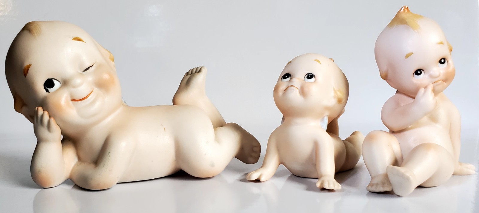 3 Vintage Lefton Bisque Posed Kewpie Baby Doll Figurines Frown Smile Wink